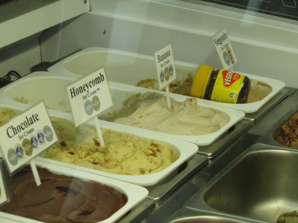 A row of different ice-cream flavours in trays, from left to right: chocolate, honecomb, banana, and vegemite. You heard that right. Vegemite ice cream.